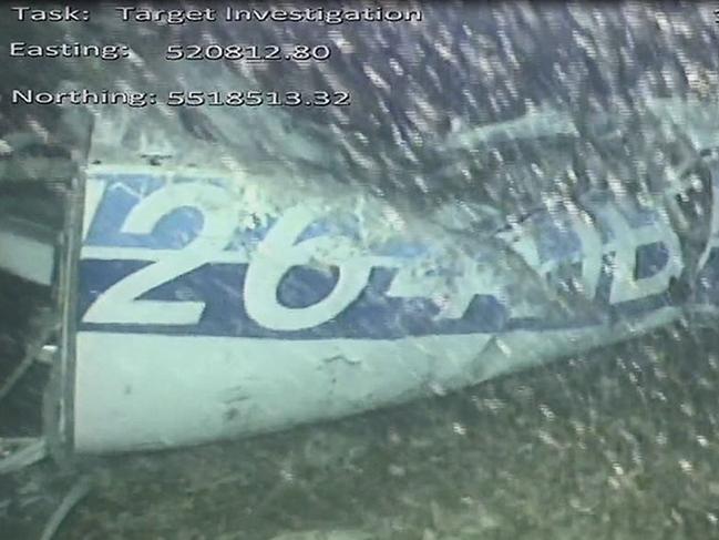 TOPSHOT - A handout video footage still image released by the UK Air Accidents Investigation Branch (AAIB) shows the rear left side of the fuselage, including part of the aircraft registration, identified as part of the wreckage from the missing Piper Malibu aircraft that disappeared two weeks ago carrying footballer Emiliano Sala and pilot David Ibbotson lying on the seabed under the English Channel. - British investigators on February 4 said they had spotted a body in underwater images of the wreckage of the plane carrying footballer Emiliano Sala and pilot David Ibbotson that disappeared in the Channel two weeks ago. (Photo by HO / AAIB / AFP) / RESTRICTED TO EDITORIAL USE - MANDATORY CREDIT 