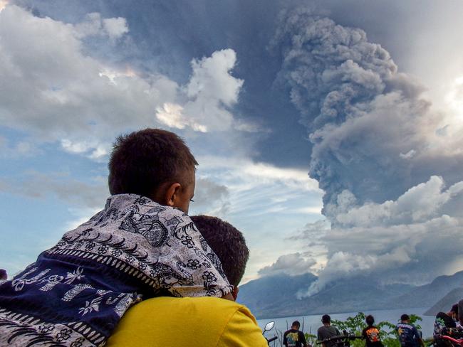 Residents watch the eruption of Mount Lewotobi Laki Laki from Eputobi village in Titihena. Picture: AFP