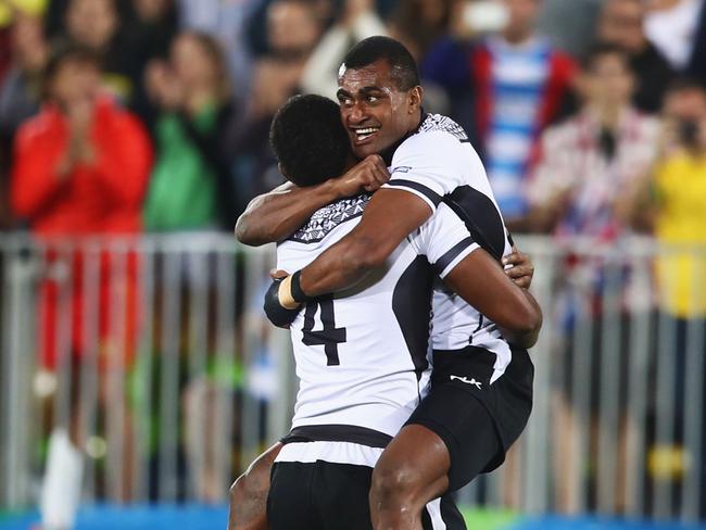 RIO DE JANEIRO, BRAZIL - AUGUST 11: Apisai Domolailai and Viliame Mata of Fiji celebrate as they win gold after the Men's Rugby Sevens Gold medal final match between Fiji and Great Britain on Day 6 of the Rio 2016 Olympics at Deodoro Stadium on August 11, 2016 in Rio de Janeiro, Brazil. (Photo by Mark Kolbe/Getty Images)