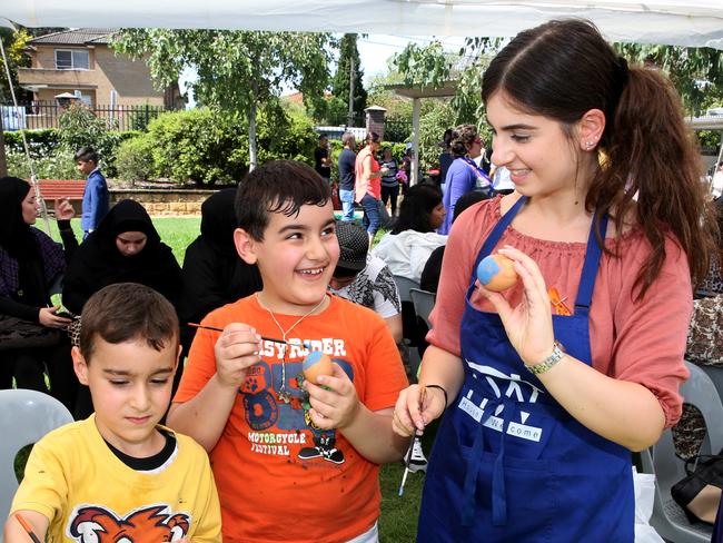 Sophie Habib teaches boys to paint eggs, a tradition adapted from Easter celebrations.