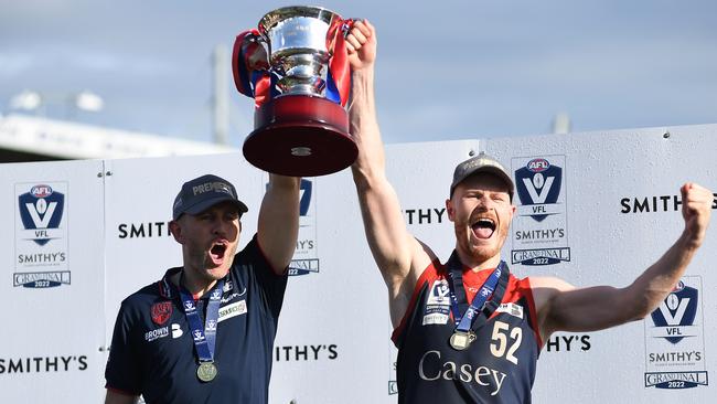 MELBOURNE, AUSTRALIA - SEPTEMBER 18: Mark Corrigan, coach of the Casey Demons and Mitch White of the Casey Demons celebrate after the 2022 VFL Grand Final match between the Casey Demons and the Southport Sharks at Ikon Park on September 18, 2022 in Melbourne, Australia. (Photo by Felicity Elliott/AFL Photos via Getty Images)