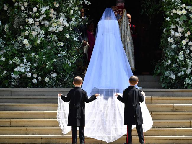 Meghan Markle arrives for the wedding ceremony with her page boys holding her train. Picture: AFP