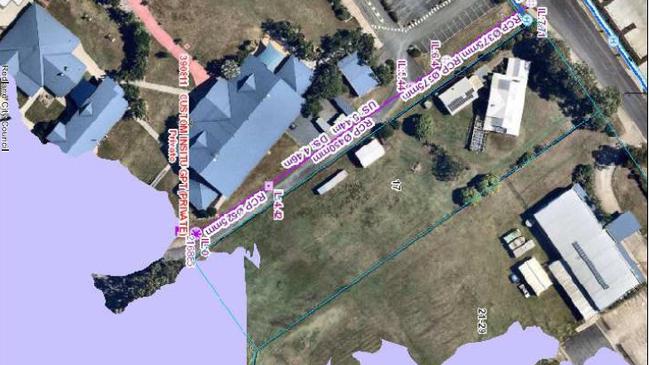 An aerial shot of the site outlined in blue with a flood overlay in purple showing impacts on Faith Luthern College on the left and the Champions Church on the right.