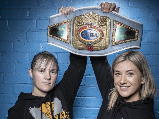 Krystina Jacobs, left, and opponent Lorrinda Webb with the title belt that was up for grabs. Picture: Eddie Safarik