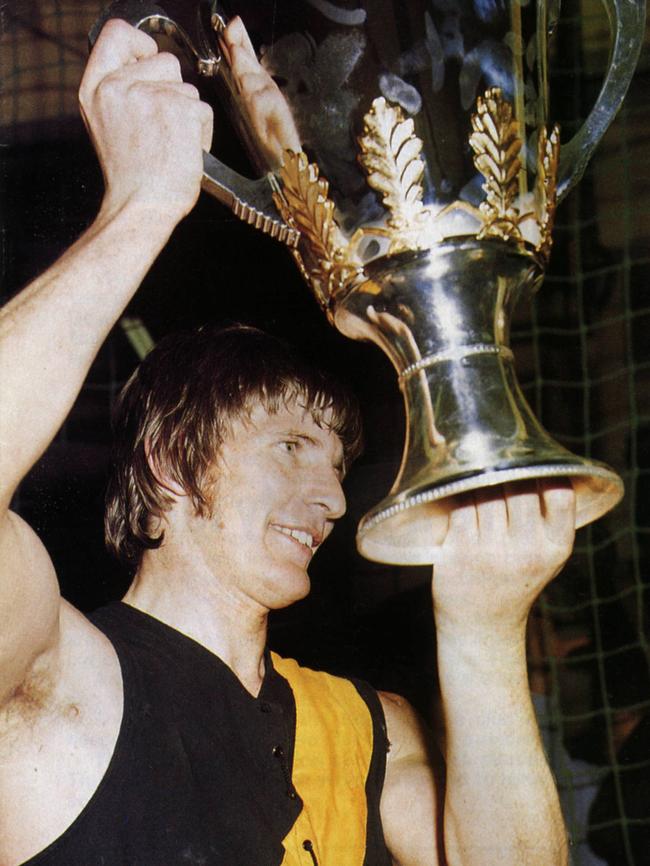 Royce Hart holds up the premiership cup after defeating Carlton in 1973.