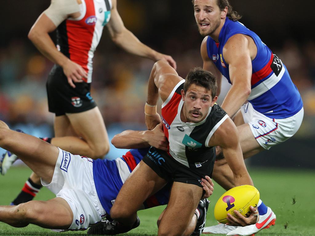 Ben Long of the Saints looks to clear as he is tackled.