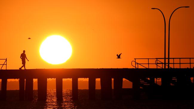 Braced for a hot one: Sunrise at Altona Pier. in Melbourne today. Picture: Nicole Garmston