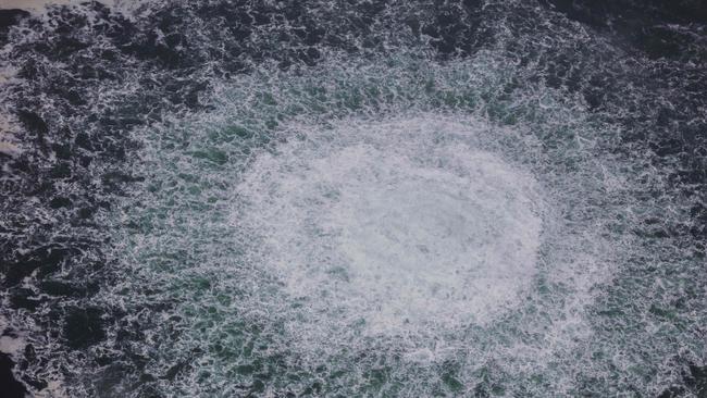 (FILES) This handout photo taken on September 28, 2022 from an aircraft of the Swedish Coast Guard (Kustbevakningen) shows the release of gas emanating from a leak on the Nord Stream 1 gas pipeline, in the Swedish economic zone in the Baltic Sea. A Swedish prosecutor probing the 2022 sabotage of the Nord Stream gas pipelines linking Russia and Germany said on February 7, 2024 he was closing the investigation because Sweden does not have jurisdiction. (Photo by Handout / SWEDISH COAST GUARD / AFP) / RESTRICTED TO EDITORIAL USE - MANDATORY CREDIT "AFP PHOTO /  SWEDISH COAST GUARD" - NO MARKETING - NO ADVERTISING CAMPAIGNS - DISTRIBUTED AS A SERVICE TO CLIENTS