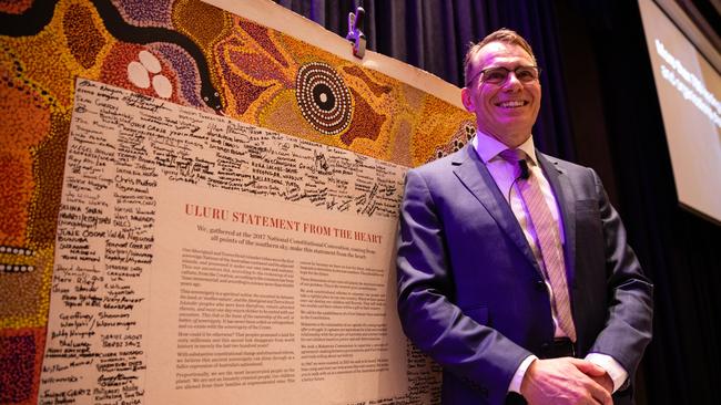 BHP Chief Executive Officer Andrew Mackenzie poses for a photograph next to the original Uluru Statement in Perth in 2019. Leadership is about tackling the uncomfortable, speaking for the voiceless, ensuring that minorities are not marginalised. Picture: AAP