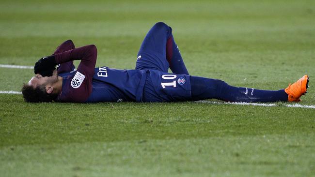 Paris Saint-Germain's Brazilian forward Neymar Jr reacts after injuring himself