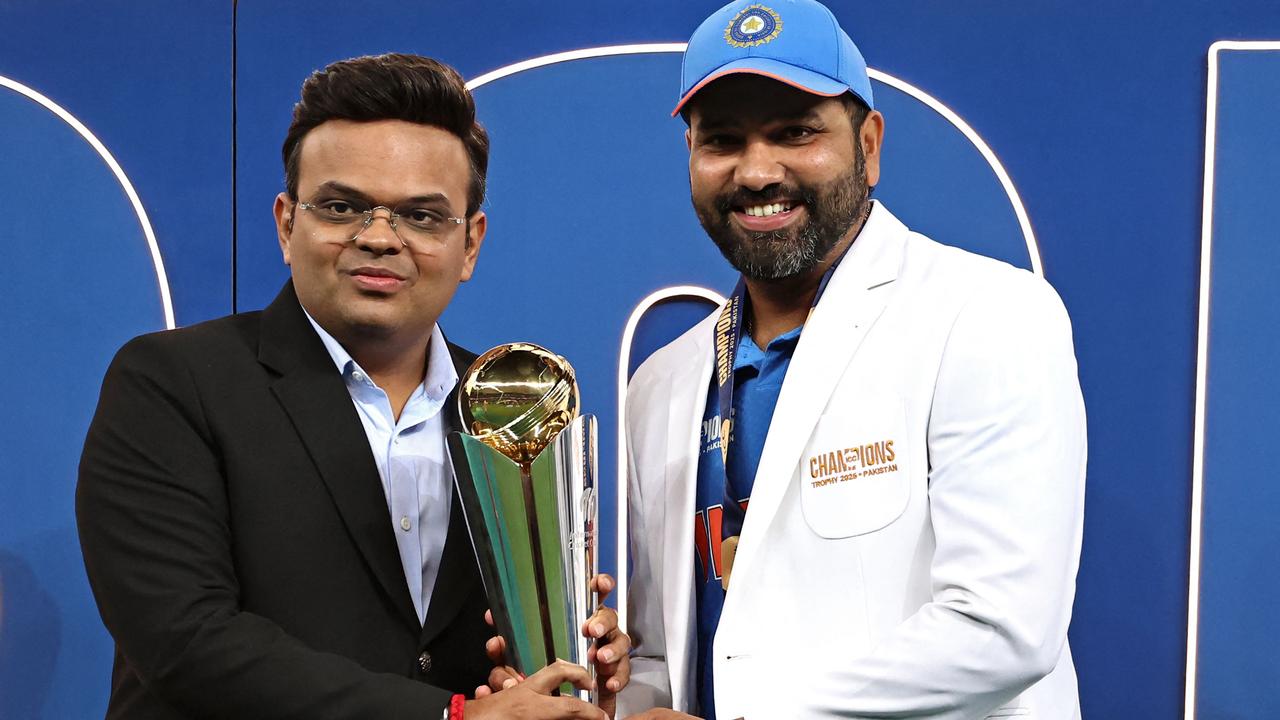 Chairman of International Cricket Council Jay Shah presents the winning trophy to India's captain Rohit Sharma. Photo by FADEL SENNA / AFP