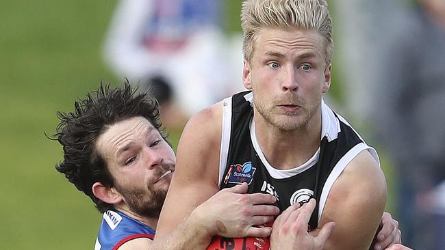 Port Adelaide’s Billy Frampton marks in front of Central’s Ryan Llewellyn. Picture: SARAH REED