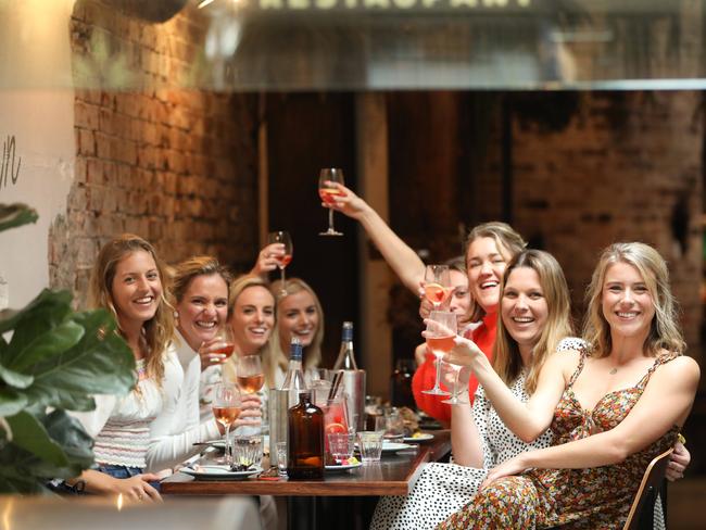 Tory Dart (Front right, floral dress) pictured with her friends for an end of lock down celebration at Bondi. Picture: Damian Shaw