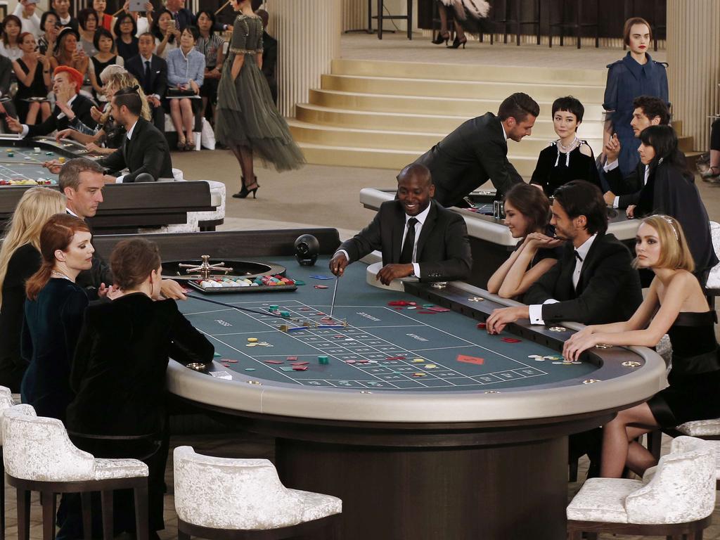 Kristen Stewart , Julianne Moore, Lara Stone, Lily-Rose Depp and French model Baptiste Giabiconi sit at a casino table during the Chanel 2015-2016 fall/winter Haute Couture collection fashion show. Picture: AFP