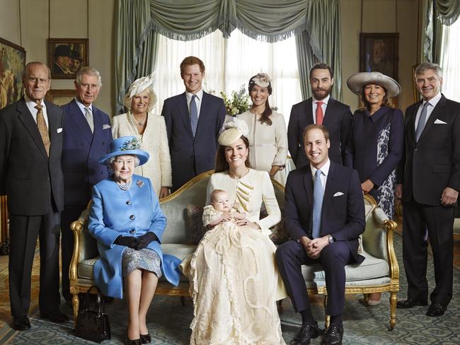 New addition ... Kate Duchess of Cambridge holds her son Prince George seated next to Queen Elizabeth II and Prince William, back row from left, Prince Philip, Prince Charles, and the Duchess of Cornwall, Prince Harry, Pippa Middleton, James Middleton, Carole Middleton and Michael Middleton. Picture: AP
