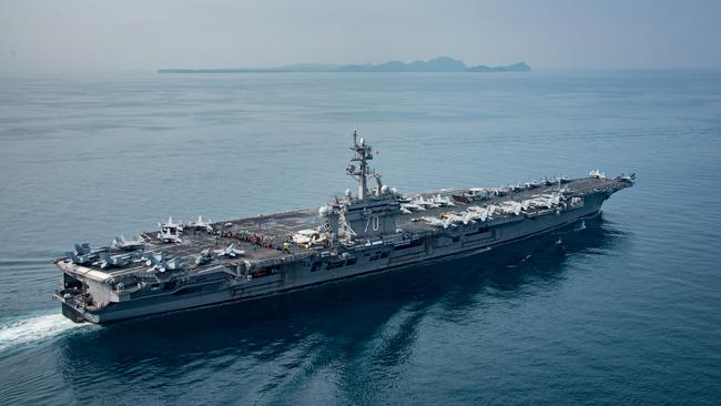 This picture, handed out by the US Navy, shows the aircraft carrier USS Carl Vinson in the Sunda Strait on Saturday, thousands of kilometres away from the Korean Peninsula. Picture: Mass Communication Specialist 2nd Class Sean M Castellano/US Navy via Getty Images