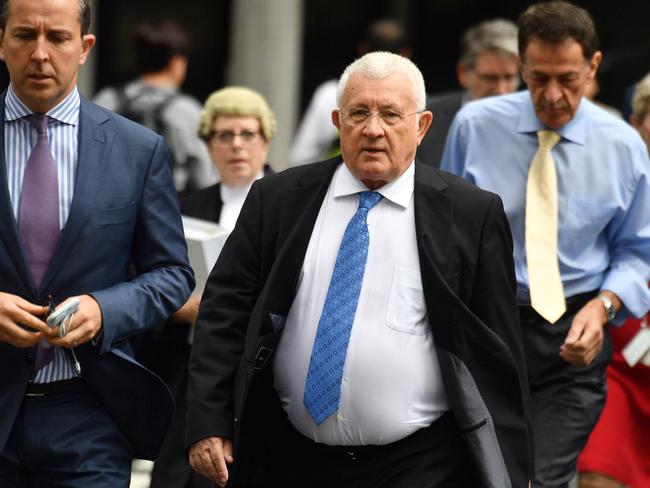 Property developer Ron Medich (centre) before he was found guilty. Picture: Mick Tsikas