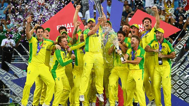 Aaron Finch jumps for job with the T20 World Cup trophy in Dubai. Picture: Alex Davidson/Getty Images