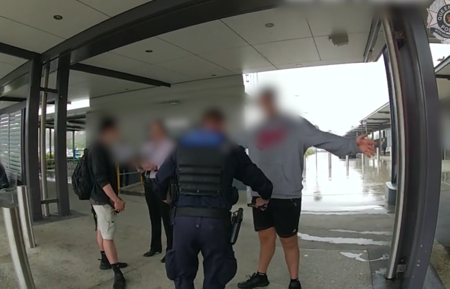 Officers from Taskforce Guardian wand a man at Helensvale train station. Picture: Queensland Police Service.