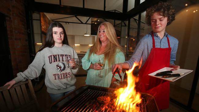 Melbourne woman Emily Perkins at home in Highett having a barbecue with her daughter Manon and son Hugo. Picture: Ian Currie