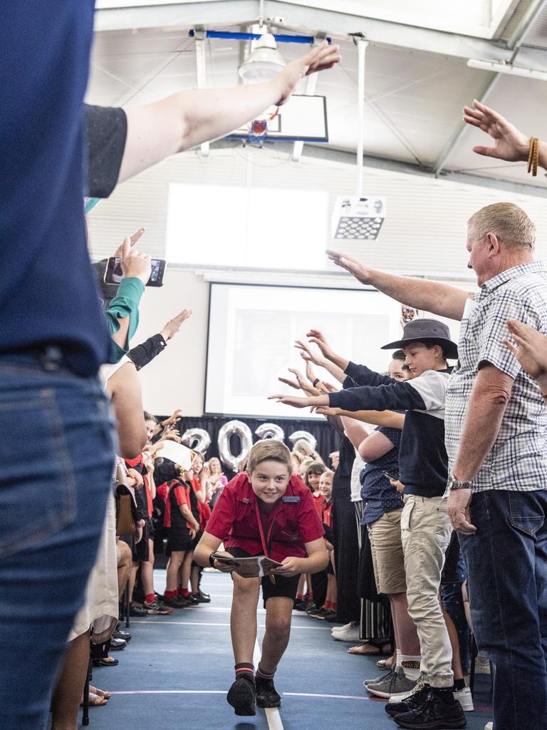 Sacred Heart Primary School Year 6 student Lachlan Honnery leaves the awards presentation and Yr 6 graduation under the arch of honour formed by attendees, Friday, December 2, 2022. Picture: Kevin Farmer