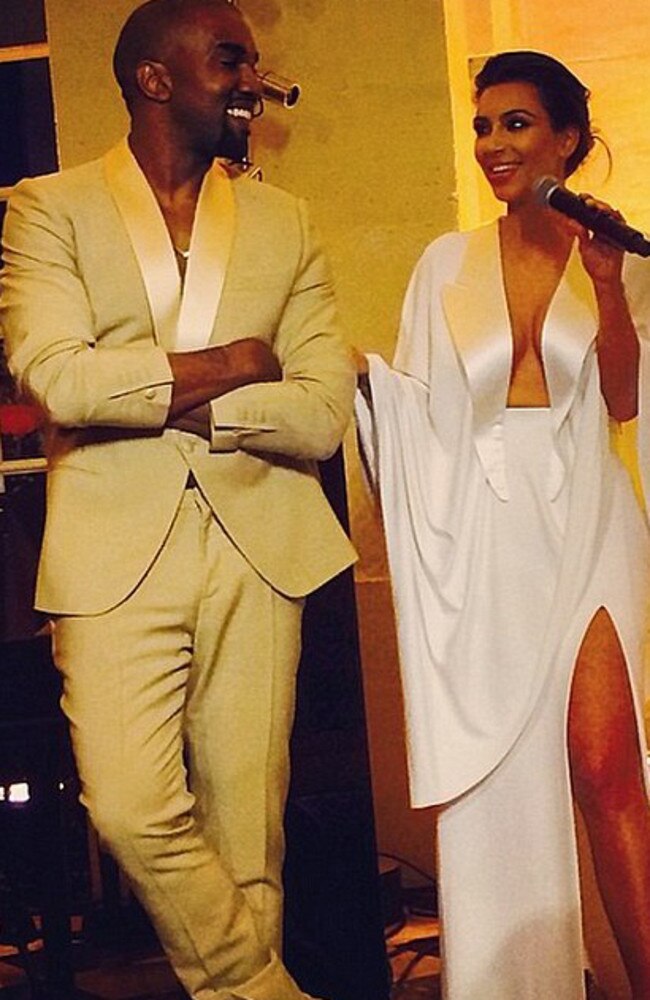 Loved up: Kanye and Kim at their rehearsal dinner. Credit: Instagram