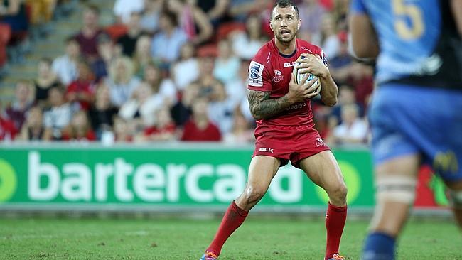 Quade Cooper clutches the ball close to his chest and considers his options against the Western Force.