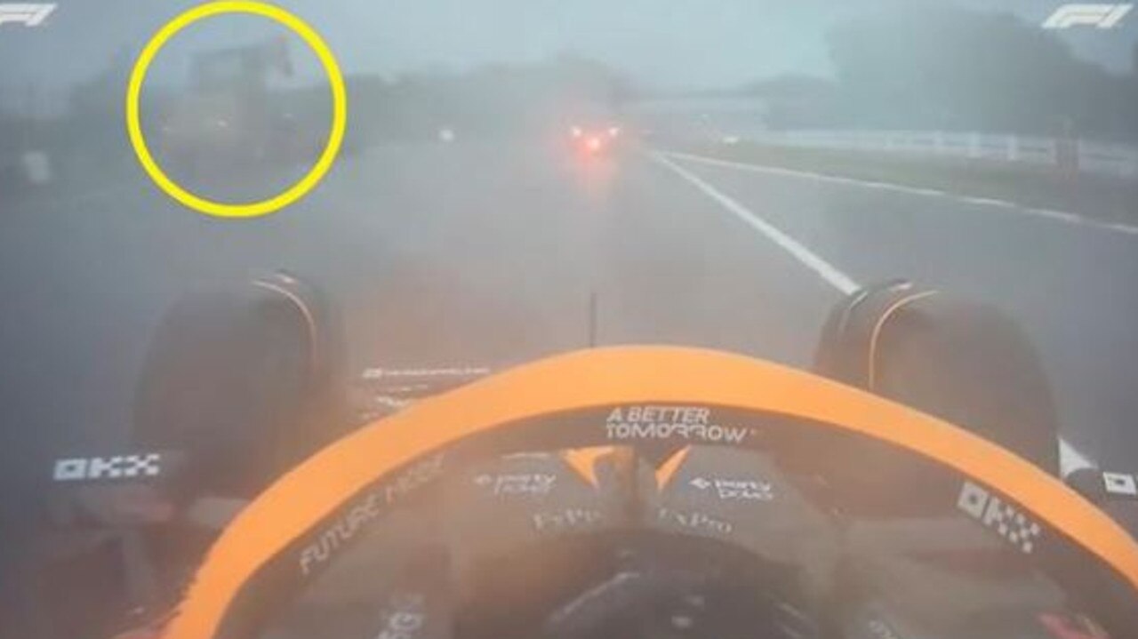 French driver Pierre Gasly passes the stationary recovery vehicle during the treacherous racing conditions.