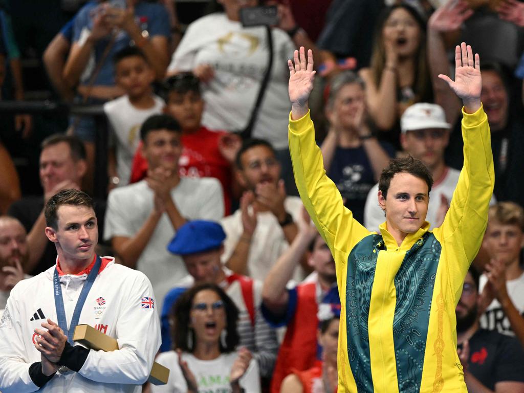 On the podium, right, after winning gold in the men's 50m freestyle swimming in Paris. Picture: AFP