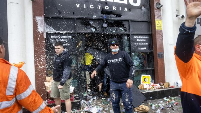 People emerge from the union headquarters after it was attacked. Picture: David Geraghty