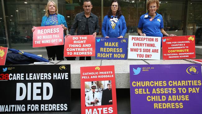 Protesters hold signs outside Melbourne County Court on March 13. Picture: Michael Dodge/Getty Images