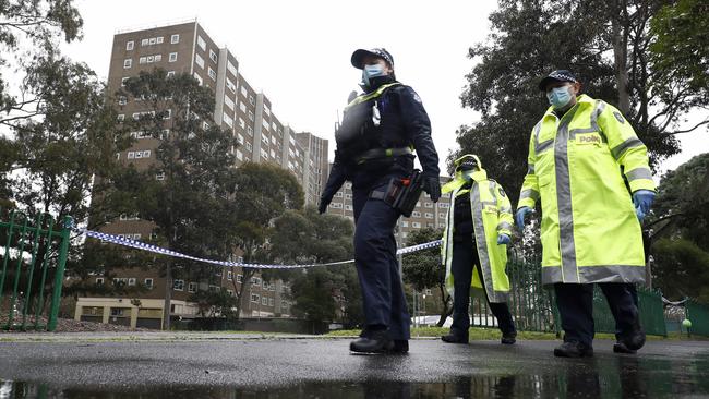 Members of Victoria Police patrol outside a locked down public housing tower in Alfred Street, North Melbourne on July 11.