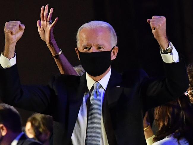 TOPSHOT - US President-elect Joe Biden gestures in celebration after delivering remarks in Wilmington, Delaware, on November 7, 2020, after being declared the winners of the presidential election. - Democrat Joe Biden was declared winner of the US presidency November 7, defeating Donald Trump and ending an era that convulsed American politics, shocked the world and left the United States more divided than at any time in decades. (Photo by ANGELA  WEISS / AFP)