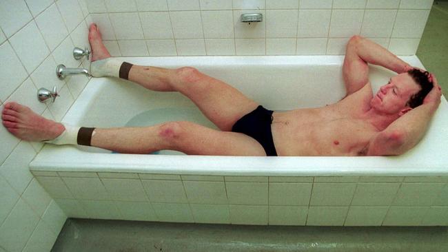 Garry Hocking sits in a bath after his last game of AFL football.