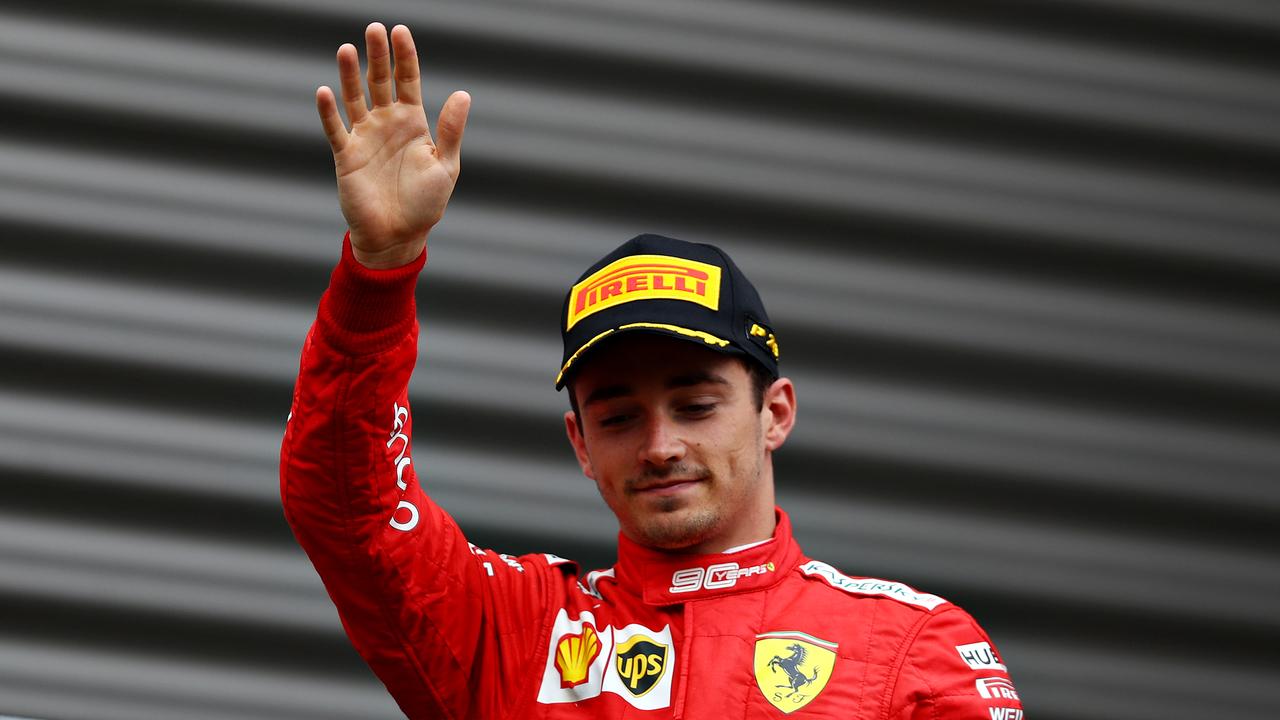 Race winner Charles Leclerc arrives on the podium in Belgium.