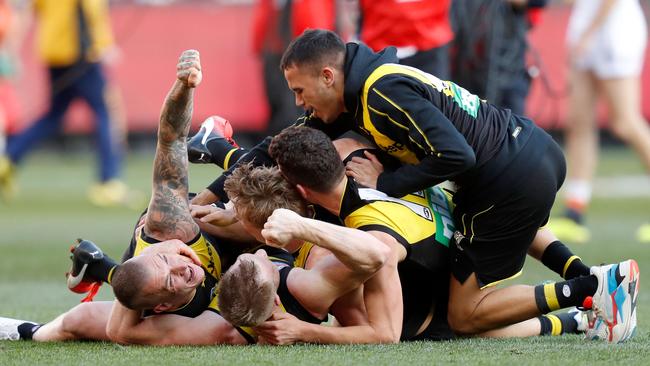 Richmond players celebrate as the final siren sounds during the 2019 AFL Grand Final. Picture: Darrian Traynor/AFL Photos/via Getty Images.