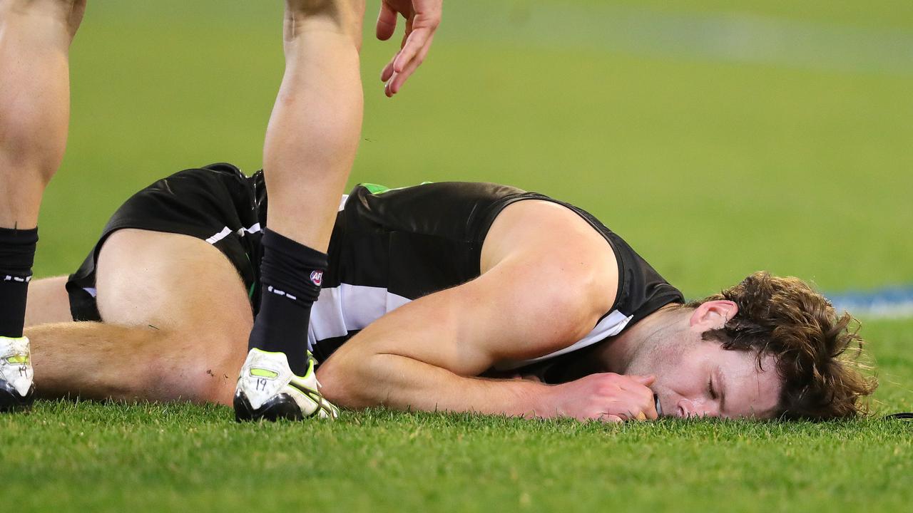 Collingwood’s Matt Scharenberg is hurt after a friendly fire incident with Levi Greenwood. Picture: Michael Klein