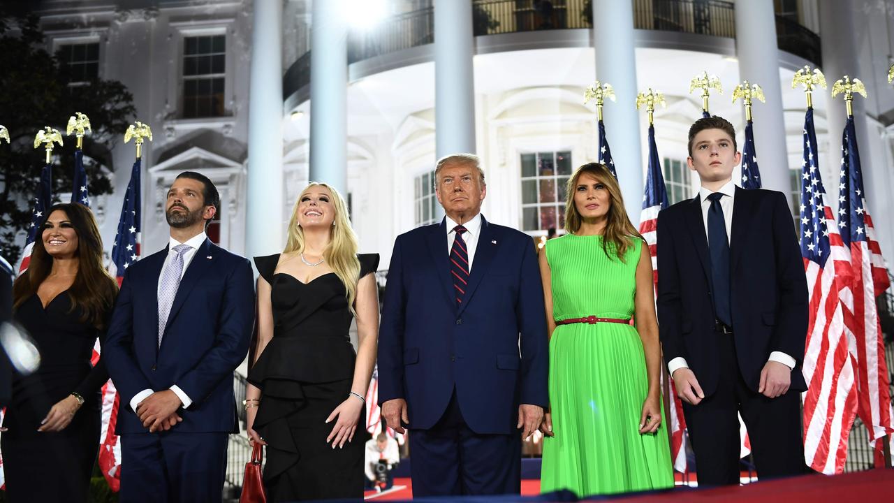 Mrs Trump, in green, with son Barron (far right), the President and, from left, Kimberly Guilfoyle, Donald Trump Jr and Tiffany Trump last year. Picture: Brendan Smialowski/AFP