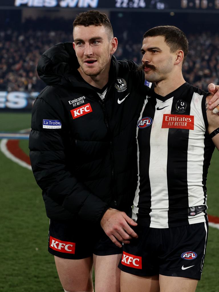 Oleg Markov (right) consoled his mate as the Magpie faithful feared the worst. Photo by Michael Klein.