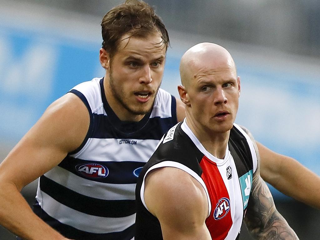 GEELONG, AUSTRALIA - AUGUST 14: Zak Jones of the Saints is tackled by Jake Kolodjashnij of the Cats during the 2021 AFL Round 22 match between the Geelong Cats and the St Kilda Saints at GMHBA Stadium on August 14, 2021 in Geelong, Australia. (Photo by Dylan Burns/AFL Photos via Getty Images)