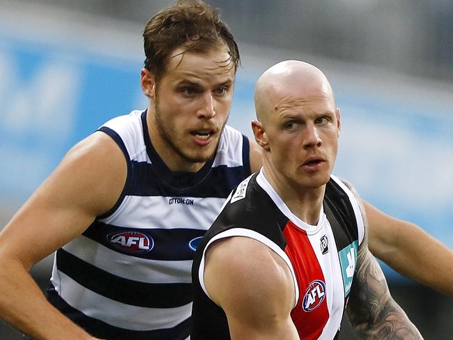 GEELONG, AUSTRALIA - AUGUST 14: Zak Jones of the Saints is tackled by Jake Kolodjashnij of the Cats during the 2021 AFL Round 22 match between the Geelong Cats and the St Kilda Saints at GMHBA Stadium on August 14, 2021 in Geelong, Australia. (Photo by Dylan Burns/AFL Photos via Getty Images)