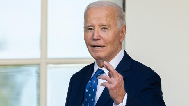 US President Joe Biden crosses his fingers as he answers a question about a Gaza ceasefire at the White House. Picture: AFP.