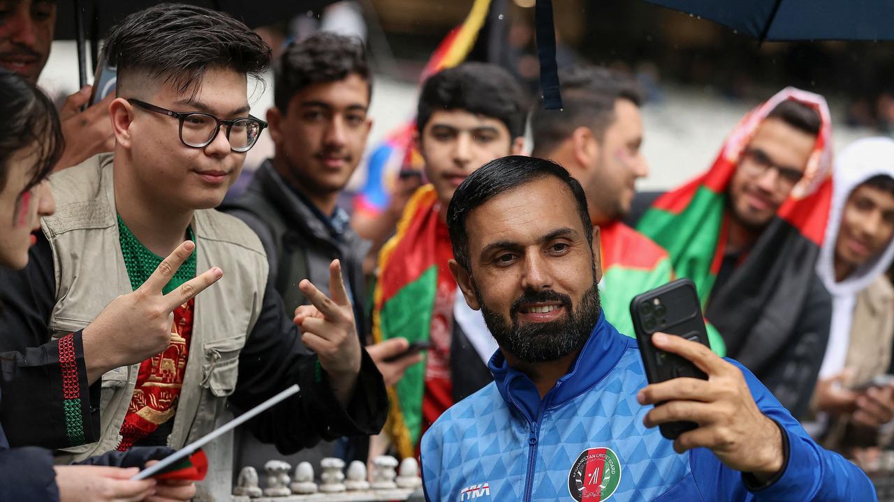 Afghanistan's Mohammad Nabi poses for selfies during the ICC men's Twenty20 World Cup 2022 cricket match between Afghanistan and Ireland at Melbourne Cricket Ground (MCG) in Melbourne on October 28, 2022. (Photo by Martin KEEP / AFP)