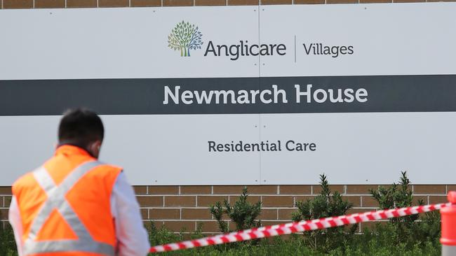 Security putting tape up at the entrance of Newmarch House. Picture: Richard Dobson