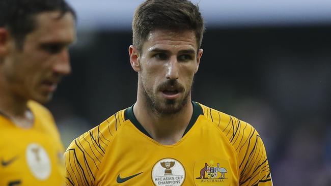 Australia's midfielder Mark Milligan, defender Milos Degenek and forward Jamie Maclaren, from left, walk along the pitch at the end of the AFC Asian Cup group B soccer match between Australia and Jordan at Hazza bin Zayed stadium in Al Ain, United Arab Emirates, Sunday, Jan. 6, 2019. Jordan won 1-0. (AP Photo/Hassan Ammar)