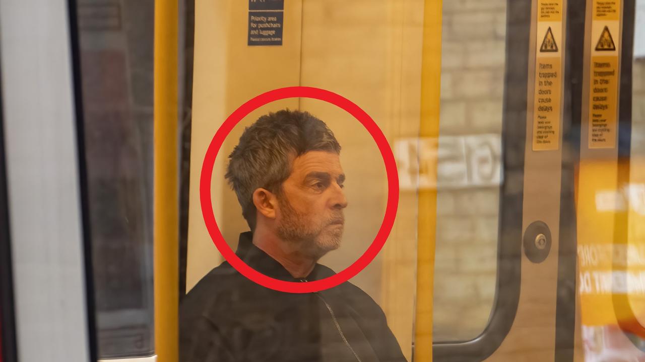 Rock icon seen catching train to rehearsal