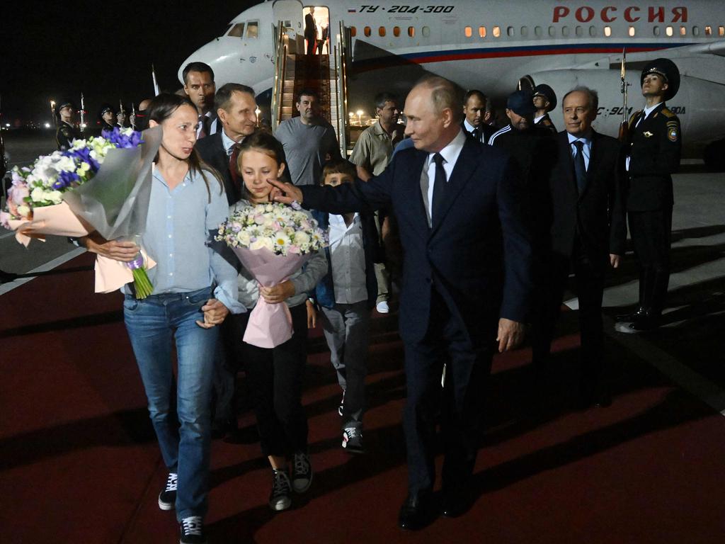 In this pool photograph distributed by Russian state agency Sputnik, Russia's President Vladimir Putin welcomes Russian citizens released in a major prisoner swap with the West, at Moscow's Vnukovo airport. Picture: AFP