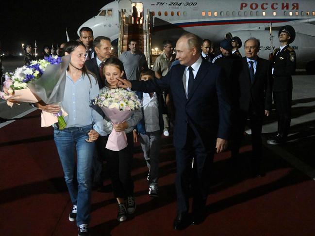 In this pool photograph distributed by Russian state agency Sputnik, Russia's President Vladimir Putin welcomes Russian citizens released in a major prisoner swap with the West, at Moscow's Vnukovo airport. Picture: AFP