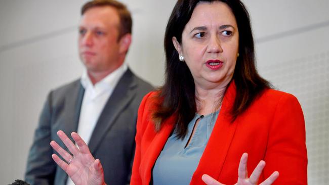 Premier Annastacia Palaszczuk talks to the media in Brisbane with her deputy Steven Miles in background. Picture: NCA NewsWire / John Gass