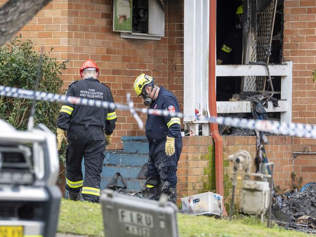 Scene of tragedy....Investigators at the house after the blaze. Picture: NewsWire / Simon Bullard.